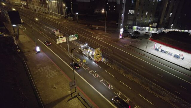 Road Workers in the UK Closing a Road Junction at Night