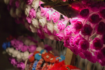 colorful hairbands for kids being sold at roadside. hairbands are made with foam flowers and feathers.