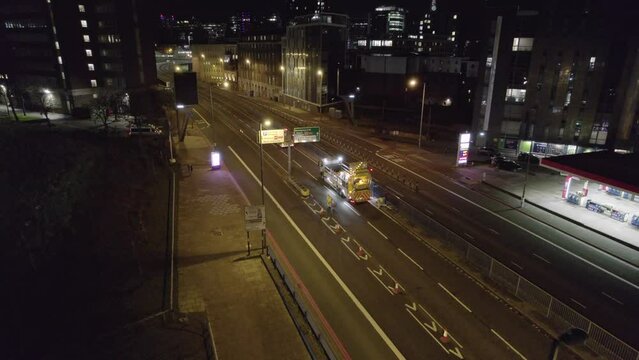 Road Workers in the UK Closing a Road Junction at Night