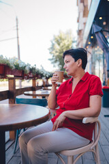 Smiling mature woman drinking coffee