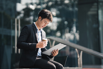 Portrait of asian businessman holding digital computer tablet. stock market concept.