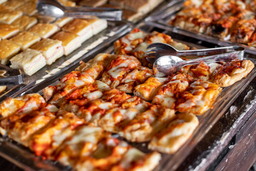 Portions of pizza on tray