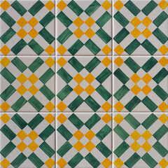 Fragment of building wall with colorful ceramic wall tiles, Azulejo close up. Abstract decorative background, textured ornate pattern for design or backdrop. Traditional ornate Portuguese architecture