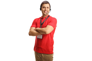 Young male dispatcher in a red t-shirt wearing a headset with hands free microphone and smiling