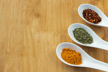 Aromatic spices on wood background. Copy space. Healthy cooking.