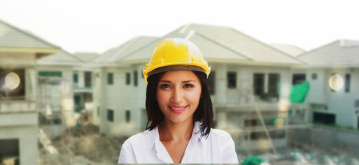 Portrait businesswoman smiling ,real estate housing project wearing helmet safety, checking...