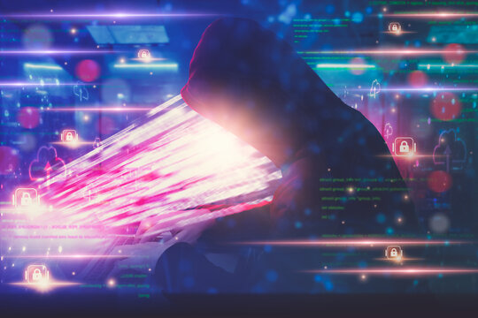 Hacker in hoodie attack laptop computer,dangerous data server and Infects system, binary code digital,hacking and malware preventing website attack concept, digital data thief cyber security concept