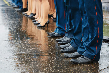 feet of squad of policemen in boots on the line