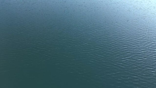Flight over the surface of a lake during light wind conditions, Arad, Romania, Europe.