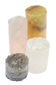 group of different drill cores isolated on white background (amethyst, rock crystal, orange calcite and rose quartz)