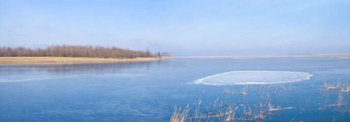 frozen lake at the bright cold day, winter outdoor landscape