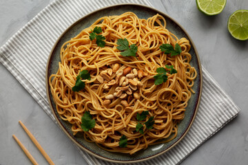 Homemade Asian Peanut Sauce Noodles on a Plate, top view. Flat lay, overhead, from above.
