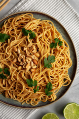 Homemade Asian Peanut Sauce Noodles on a Plate, top view. Flat lay, overhead, from above.
