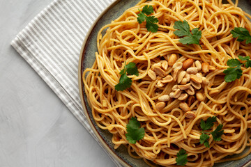 Homemade Asian Peanut Sauce Noodles on a Plate, top view. Flat lay, overhead, from above.