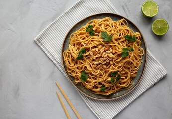 Homemade Asian Peanut Sauce Noodles on a Plate, top view. Flat lay, overhead, from above.