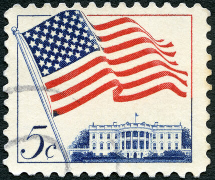 USA - 1963: shows an American Flag flying in the breeze over White House, Flag Issue, 1963
