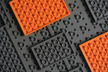 Abstract gray orange background from children construction kit.