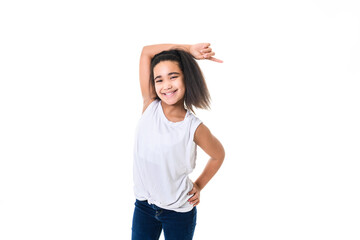 Adorable 9 years child girl on studio white background pointing with her finger