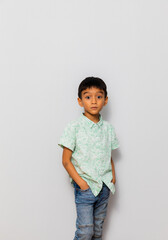 Cute little boy in casual outfit on background