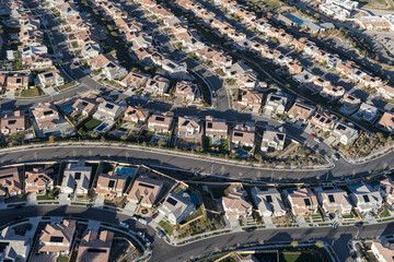 Fototapeta premium Aerial view of modern suburban homes with rooftop solar in Los Angeles County, California.