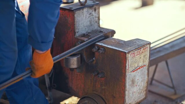 Male hand cuts off pieces of water pipe with angle grinder. Cutting of a steel with splashes of sparks at construction site. Sparks during cutting of metal angle grinder