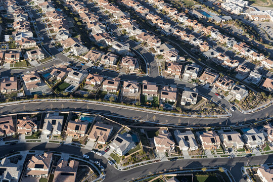 Aerial view of modern suburban homes with rooftop solar in Los Angeles County, California.