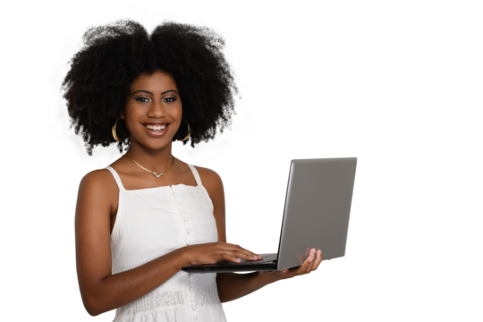 young woman typing on a laptop keyboard, looks at the camera smiling, black woman