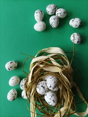 quail eggs in a nest on green background