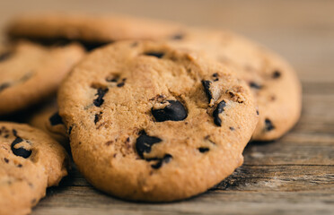 Cookies with chocolate crisps on a rustic wooden background, close-up.