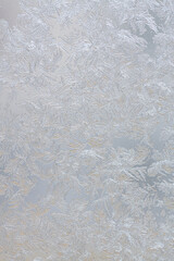 Frozen drops of condensed steam water drops on the transparent window glass. Clean blue background. Condensation of moisture at extreme temperatures. Beautiful nature texture