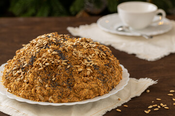 ant hill cake decorated with poppy seeds on a white plate. the concept of a festive tea party