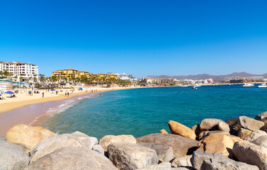 Fototapeta premium Sunny hot day at the Playa Pública public beach at the resort town of Cabo San Lucas, Mexico.