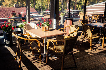 Glazing terrace of street cafe or restaurant in sunny day.