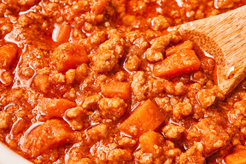 Close-up detailed view of fresh BOLOGNESE SAUCE in a pot. Focus stacking. Studio shot.