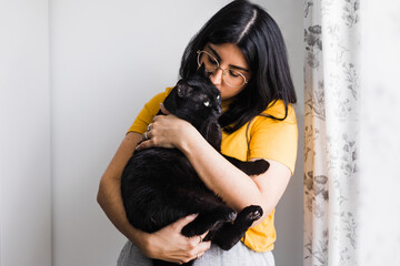 Content woman hugging cute cat