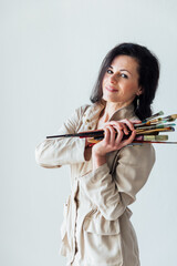 female artist with tassels standing on a white background