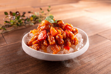Iced Sweet and Sour Pork served dish isolated on wooden table top view of Hong Kong food