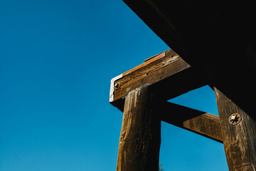 wooden beam structure detail, against blue sky