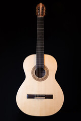 Classical guitar top isolated on black background, view from the top side. Beautiful Brazilian wood - Pau Ferro on the back and spruce on the top. Classic acoustic guitar concept. Perfect for flyer, c