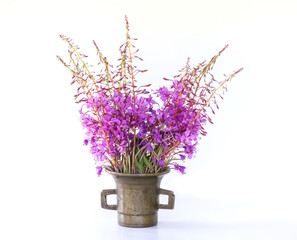 Fireweed flowers and copper mortar on the table. Medical herbs for herbal tea or cosmetic products.