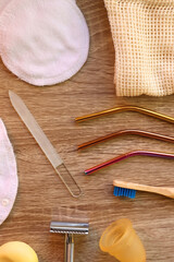 Various zero waste beauty products and kitchen utensils on wooden background. Top view.
