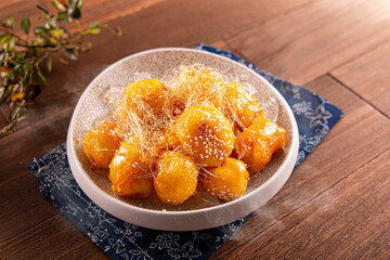 Chilled Candied Bananas served dish isolated on wooden table top view of Hong Kong food