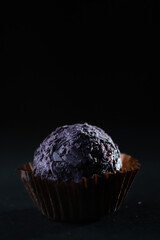 Colored round candies on a dark background