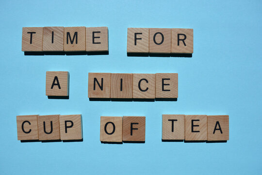 Naklejki Time for a Nice Cup of Tea, words in wooden alphabet letters isolated on blue background