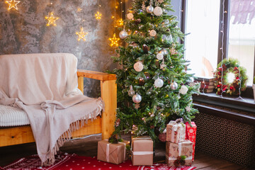 Christmas tree in brown balls with gifts. Festive interior