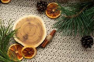 Obraz na płótnie Canvas A felled tree, dried oranges, New Year's branches on a mat