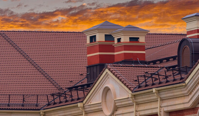 house with a roof from a burgundy shingles with a pipe  and atti