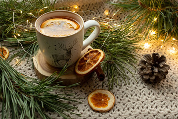 Obraz na płótnie Canvas Green tea in a craft cozy cup, dried fruit, orange and cinnamon stick