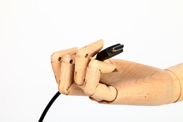 Wooden hand holding an HDMI cable isolated on a white background