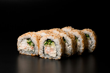 Sushi rolls California with crab meat, avocado, cucumber at dark background.